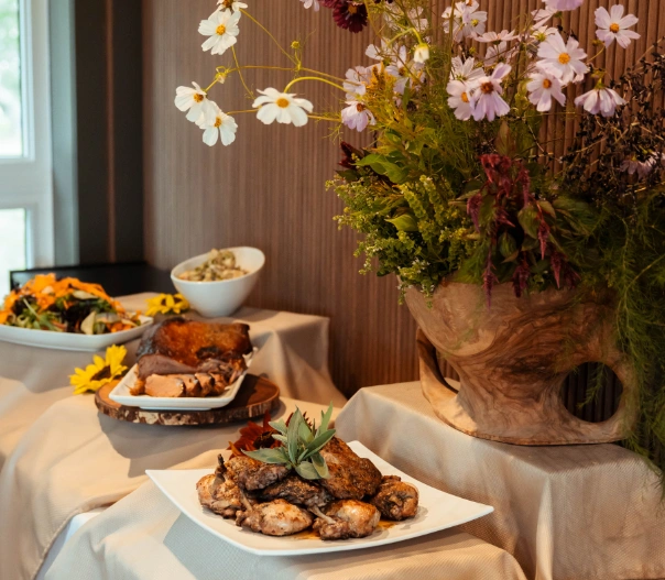 Table featuring a variety of meats, salads, and sides